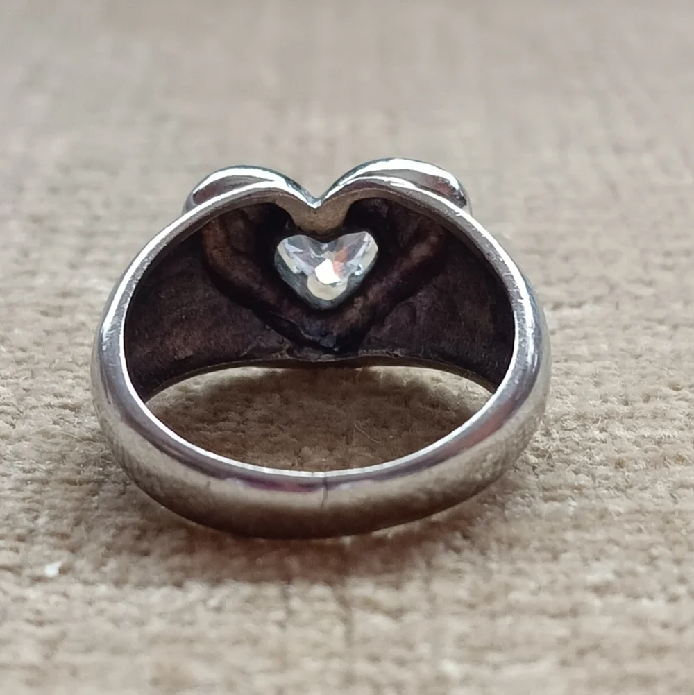 Silver Ring with a Heart Design Featuring a Sparkling Rhinestone Centerpiece.